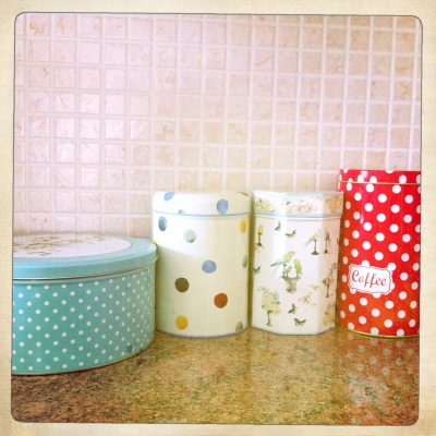 A colourful collection of different tins brighten up the kitchen bench.